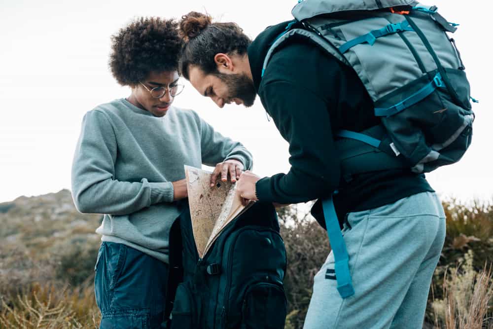 african-caucasian-young-men-looking-map-backpack